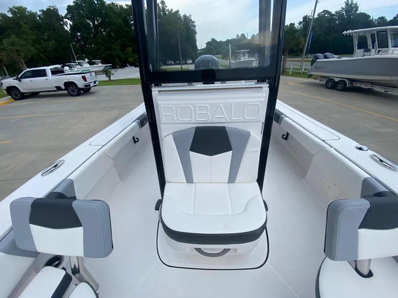 Slide: The Image of 2024 Robalo 246 Cayman boat interior with white and gray seating. - 17