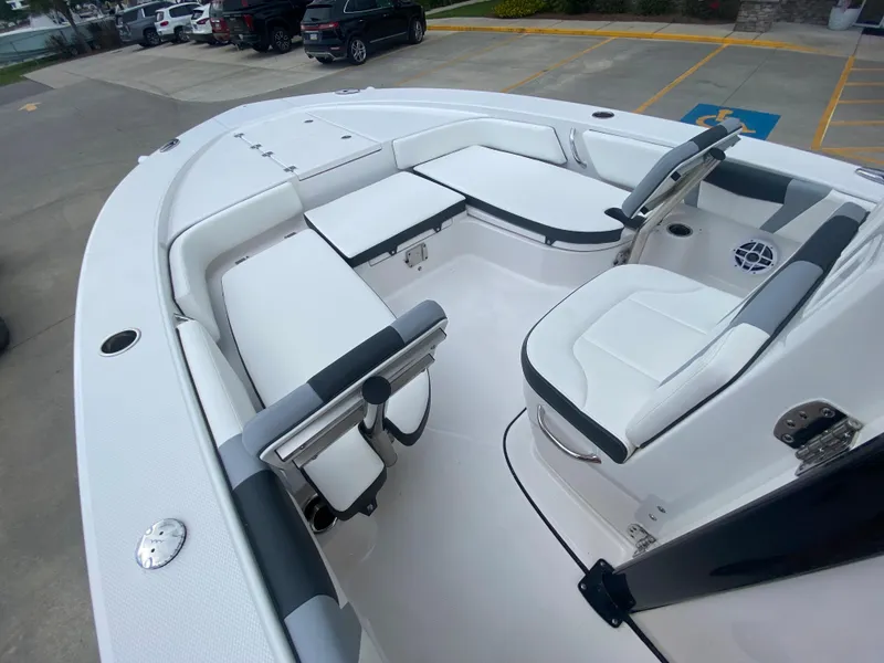 Slide: The Image of 2024 Robalo 246 Cayman boat interior with white seating and modern design. - 18