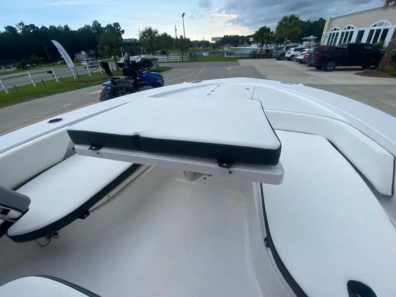 Slide: The Image of 2024 Robalo 246 Cayman boat interior with white cushioned seating. - 21