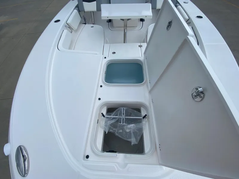 Slide: The Image of 2024 Robalo 246 Cayman boat with open storage compartments on deck. - 26