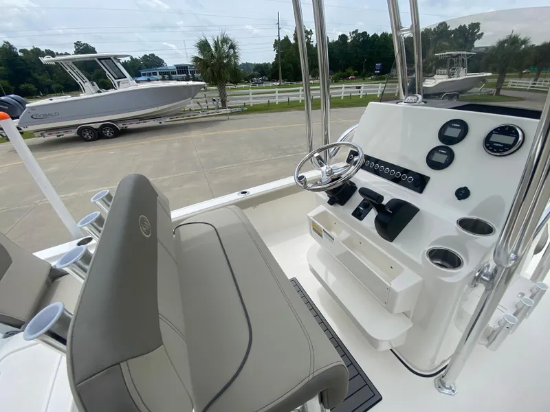 Slide: The Image of 2024 Key West 210 Bay Reef boat interior with steering console and seating. - 11