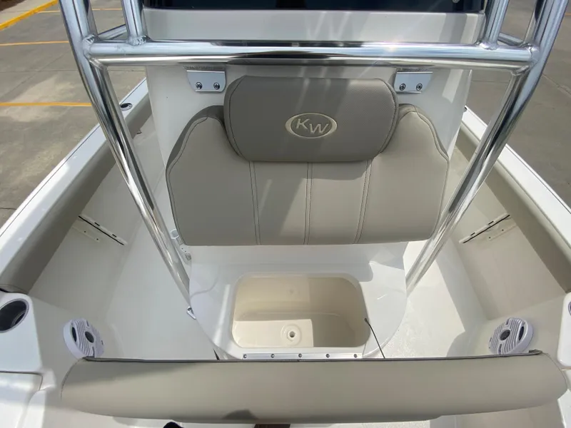 Slide: The Image of 2024 Key West 210 Bay Reef boat interior with cushioned seating and storage. - 17