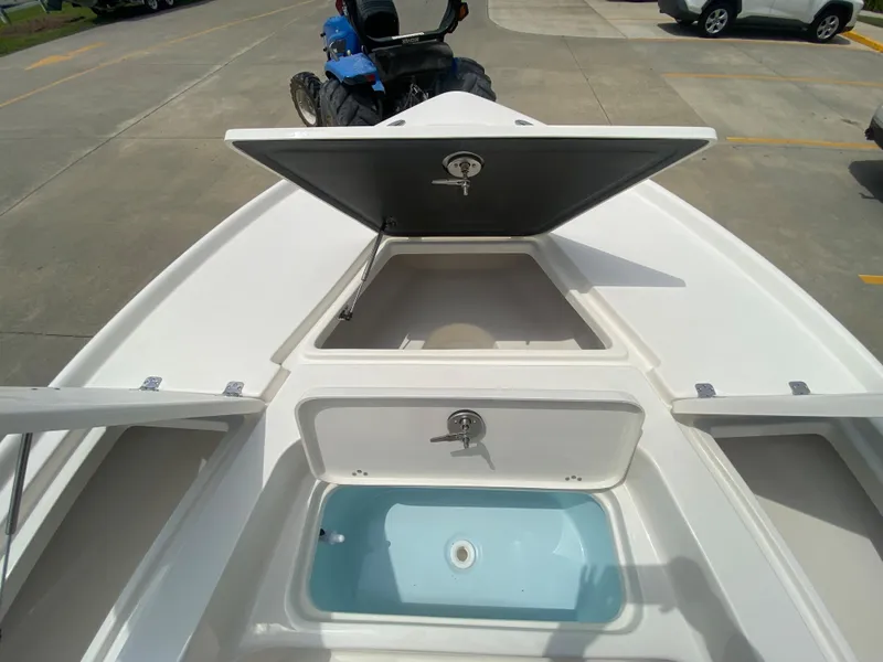 Slide: The Image of 2024 Key West 210 Bay Reef boat with open storage compartments and livewell. - 21