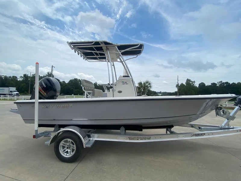 Slide: The Image of 2024 Key West 210 Bay Reef boat on a trailer under a cloudy sky. - 1
