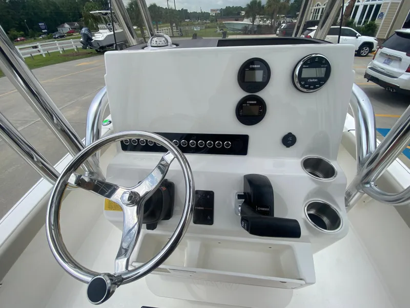 Slide: The Image of 2024 Key West 210 Bay Reef boat console with steering wheel and gauges. - 10