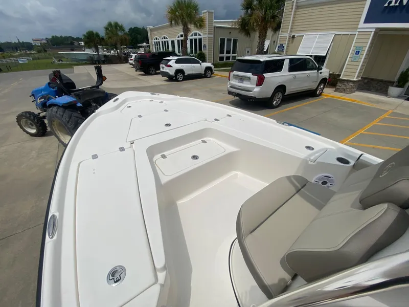 Slide: The Image of 2024 Key West 210 Bay Reef boat on display at a dealership. - 16
