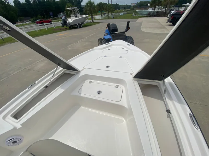 Slide: The Image of 2024 Key West 210 Bay Reef boat interior, open storage compartments, and clean white deck. - 18