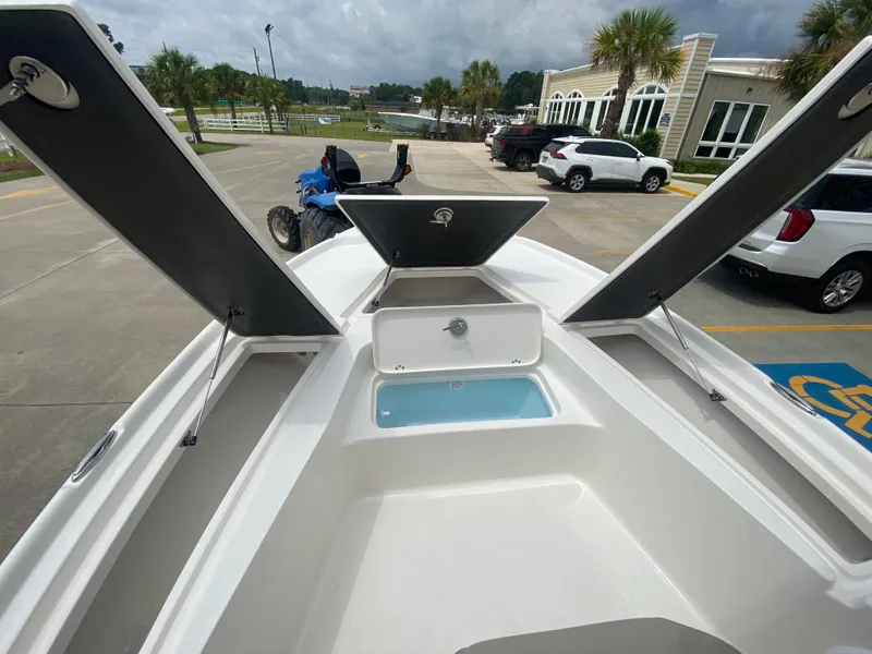 Slide: The Image of 2024 Key West 210 Bay Reef boat with open storage compartments and livewell. - 20