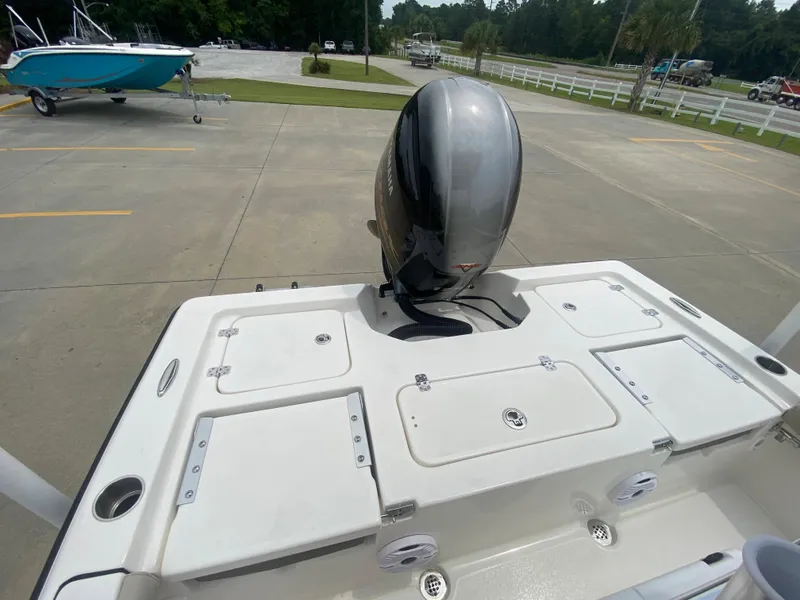 Slide: The Image of 2024 Key West 210 Bay Reef boat with outboard motor in parking lot. - 6