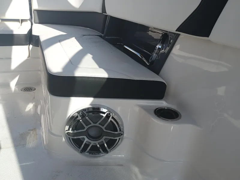 Slide: The Image of 2024 Chaparral 280 OSX boat interior with cushioned seating and speaker. - 14