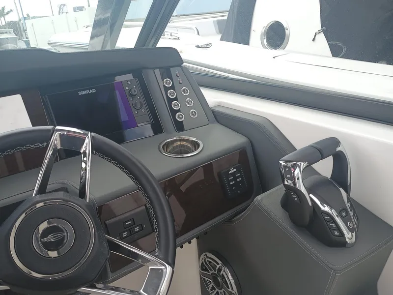 Slide: The Image of 2024 Chaparral 280 OSX boat helm with modern controls and steering wheel. - 17