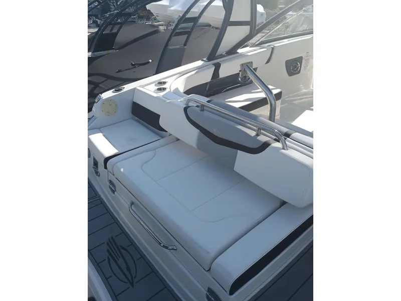 Slide: The Image of 2024 Chaparral 280 OSX boat with sleek white seating and modern design. - 21