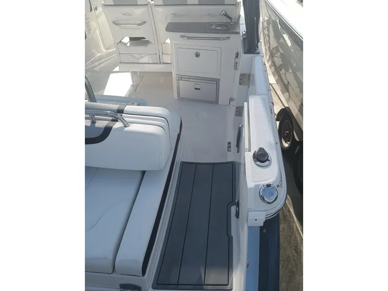 Slide: The Image of 2024 Chaparral 280 OSX boat interior with seating and storage compartments. - 22