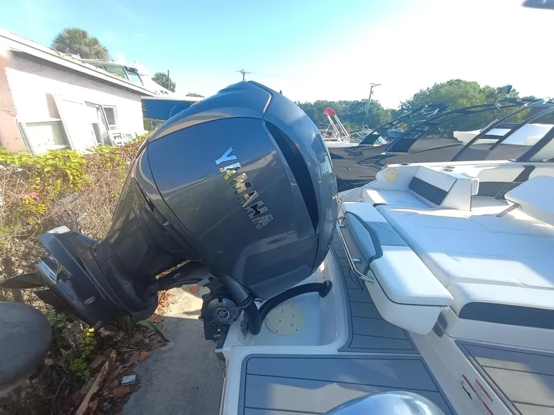 Slide: The Image of 2024 Chaparral 280 OSX boat with Yamaha outboard motor, docked outdoors. - 30