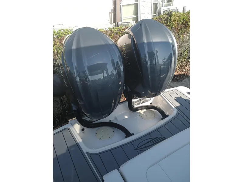 Slide: The Image of 2024 Chaparral 280 OSX boat with dual outboard engines, rear view. - 31