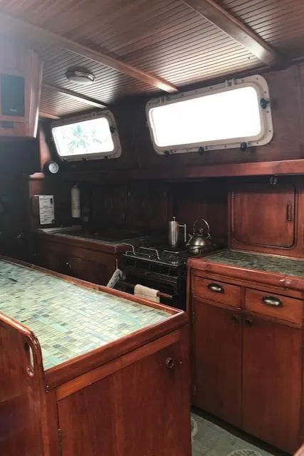 Slide: The Image of 1983 Stuart Marine 62 Custom Ketch interior with wooden cabinetry and nautical design. - 10