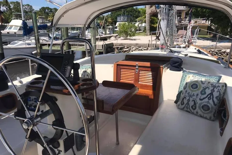 Slide: The Image of 1983 Stuart Marine 62 Custom Ketch cockpit with steering wheel, seating, and nautical decor. - 15