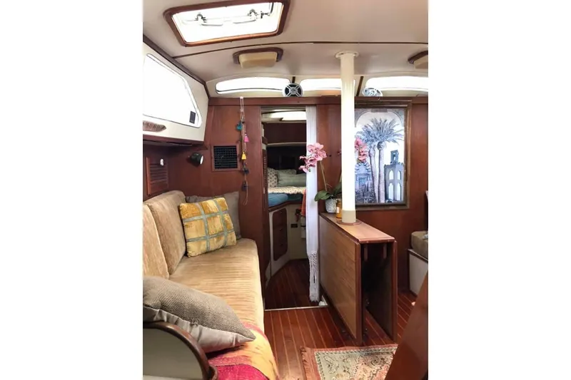 Slide: The Image of Interior of 1983 Stuart Marine 62 Custom Ketch, featuring cozy seating and elegant wood finishes. - 19