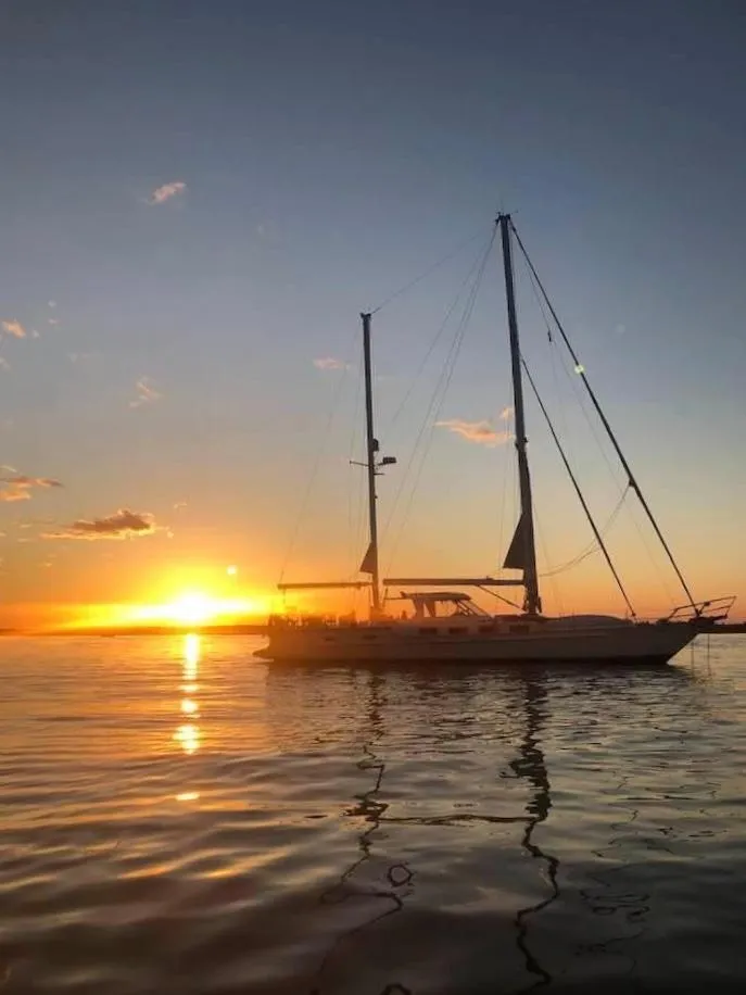 Slide: The Image of 1983 Stuart Marine 62 Custom Ketch sailing at sunset on calm waters. - 2