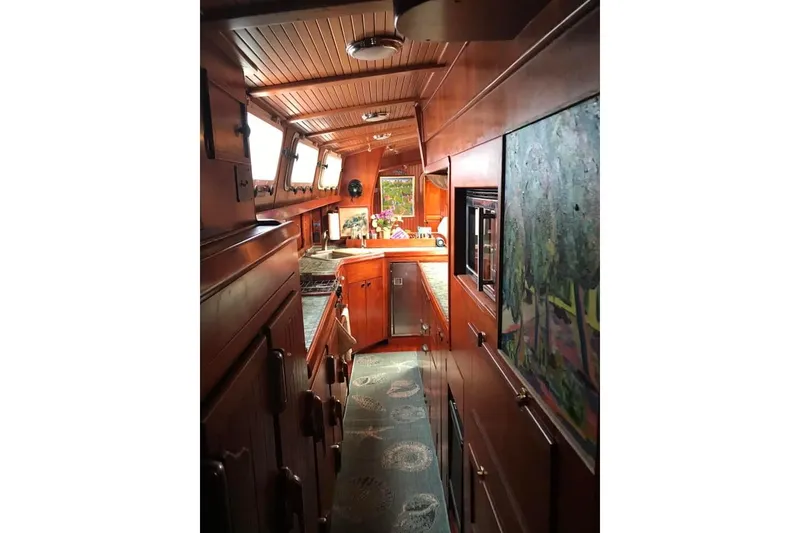 Slide: The Image of Interior of 1983 Stuart Marine 62 Custom Ketch, featuring wood paneling and nautical decor. - 21