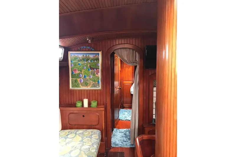 Slide: The Image of Interior of 1983 Stuart Marine 62 Custom Ketch with wood paneling and colorful artwork. - 22
