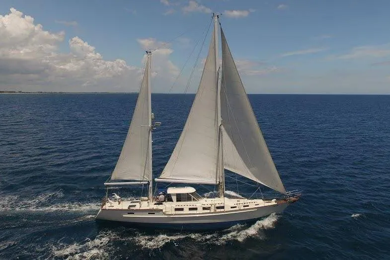 Slide: The Image of 1983 Stuart Marine 62 Custom Ketch sailing on open ocean under clear skies. - 23