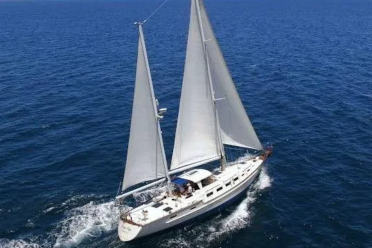 Slide: The Image of 1983 Stuart Marine 62 Custom Ketch sailing on open sea, showcasing elegant design. - 24