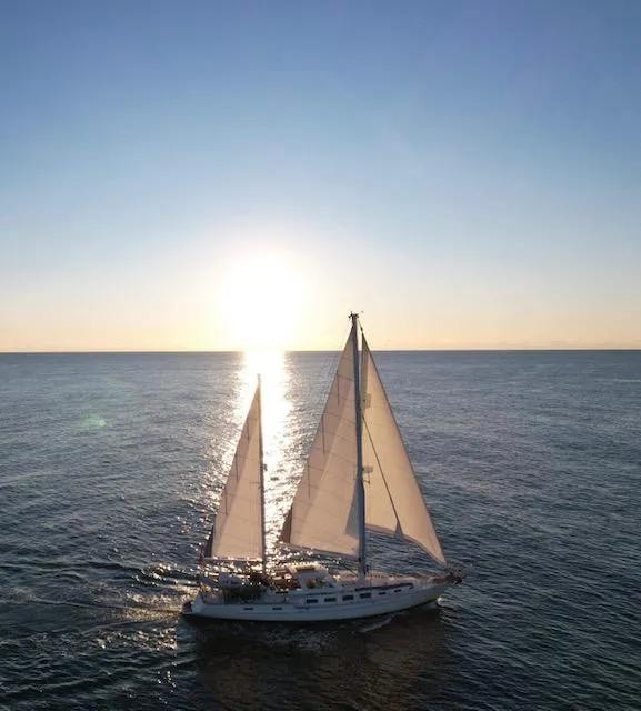 Slide: The Image of 1983 Stuart Marine 62 Custom Ketch sailing at sunset on open sea. - 3
