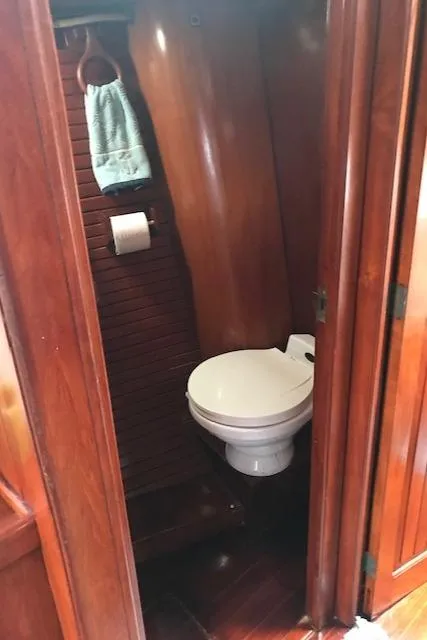 Slide: The Image of 1983 Stuart Marine 62 Custom Ketch bathroom with wooden interior and toilet. - 8