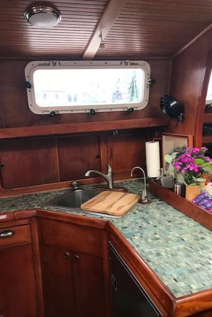 Slide: The Image of 1983 Stuart Marine 62 Custom Ketch kitchen with wood cabinetry and mosaic countertop. - 9