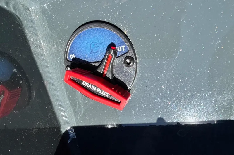 Slide: The Image of Red drain plug on 2026 Ranger RT178 boat, labeled "IN" and "OUT." - 13