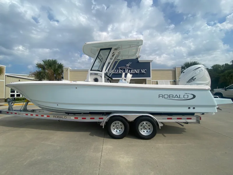The Image of 2024 Robalo 266 Cayman boat on a trailer at a dealership. - 0