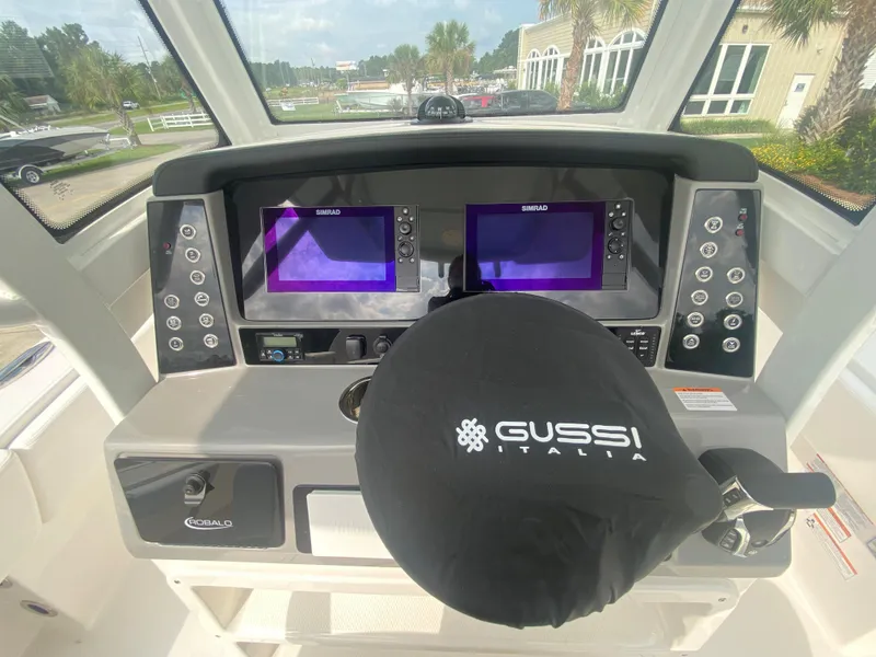 Slide: The Image of 2024 Robalo 266 Cayman helm with dual Simrad displays and Gussi Italia steering wheel. - 14