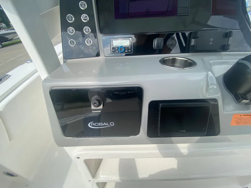 Slide: The Image of Control panel of the 2024 Robalo 266 Cayman boat with modern features. - 16