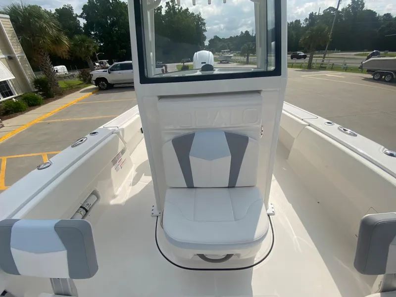 Slide: The Image of 2024 Robalo 266 Cayman boat interior with cushioned seating and console. - 20