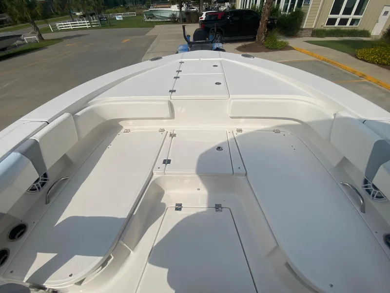 Slide: The Image of 2024 Robalo 266 Cayman boat interior, spacious deck with storage compartments. - 22