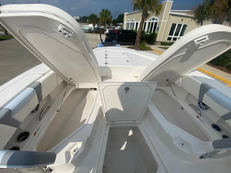 Slide: The Image of 2024 Robalo 266 Cayman boat with open storage compartments. - 23