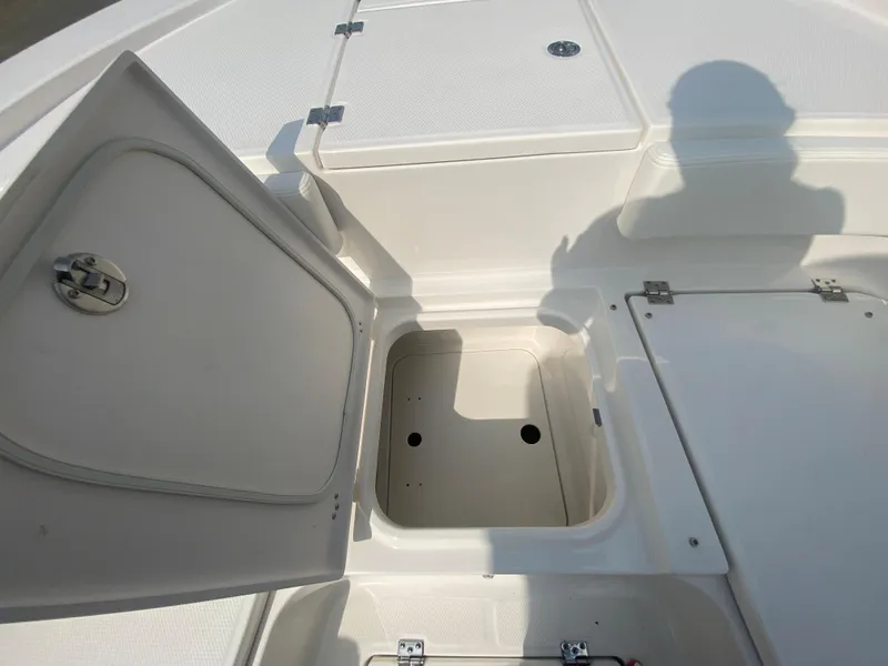 Slide: The Image of Open storage compartment on a 2024 Robalo 266 Cayman boat. - 24