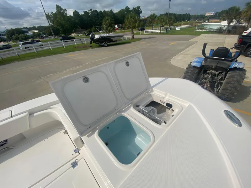 Slide: The Image of 2024 Robalo 266 Cayman boat with open storage compartments. - 27