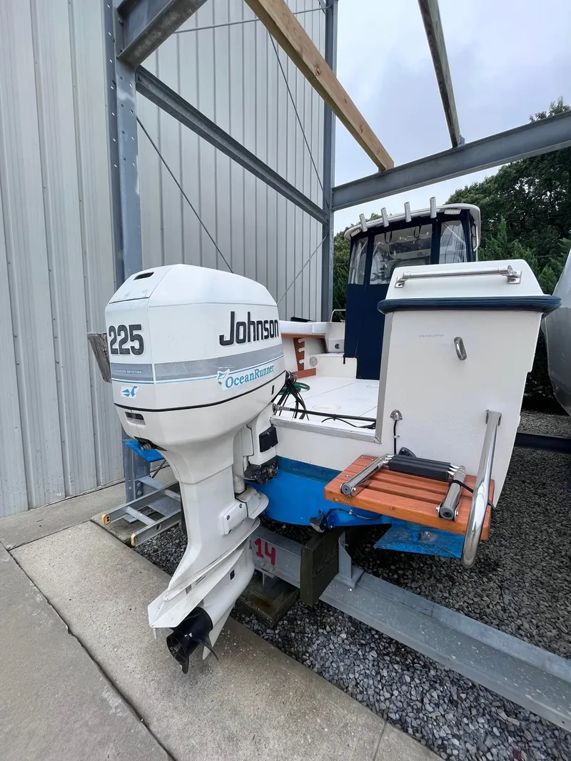 Slide: The Image of 1987 Grady-White 24 Offshore boat with Johnson 225 outboard motor in storage. - 14