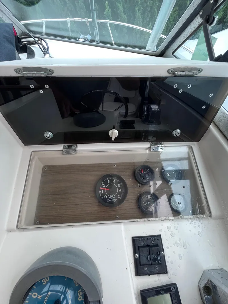 Slide: The Image of Dashboard of a 1987 Grady-White 24 Offshore boat with gauges and controls. - 4