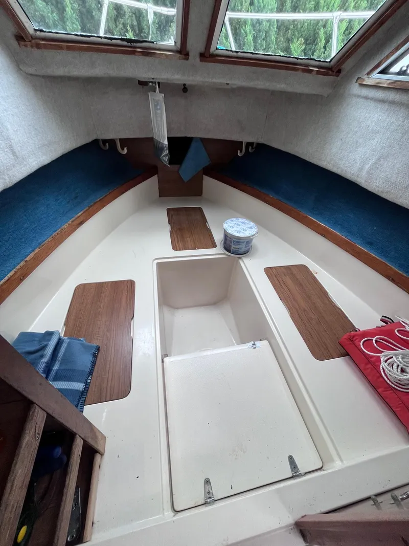 Slide: The Image of 1987 Grady-White 24 Offshore boat interior with storage compartments and seating. - 5