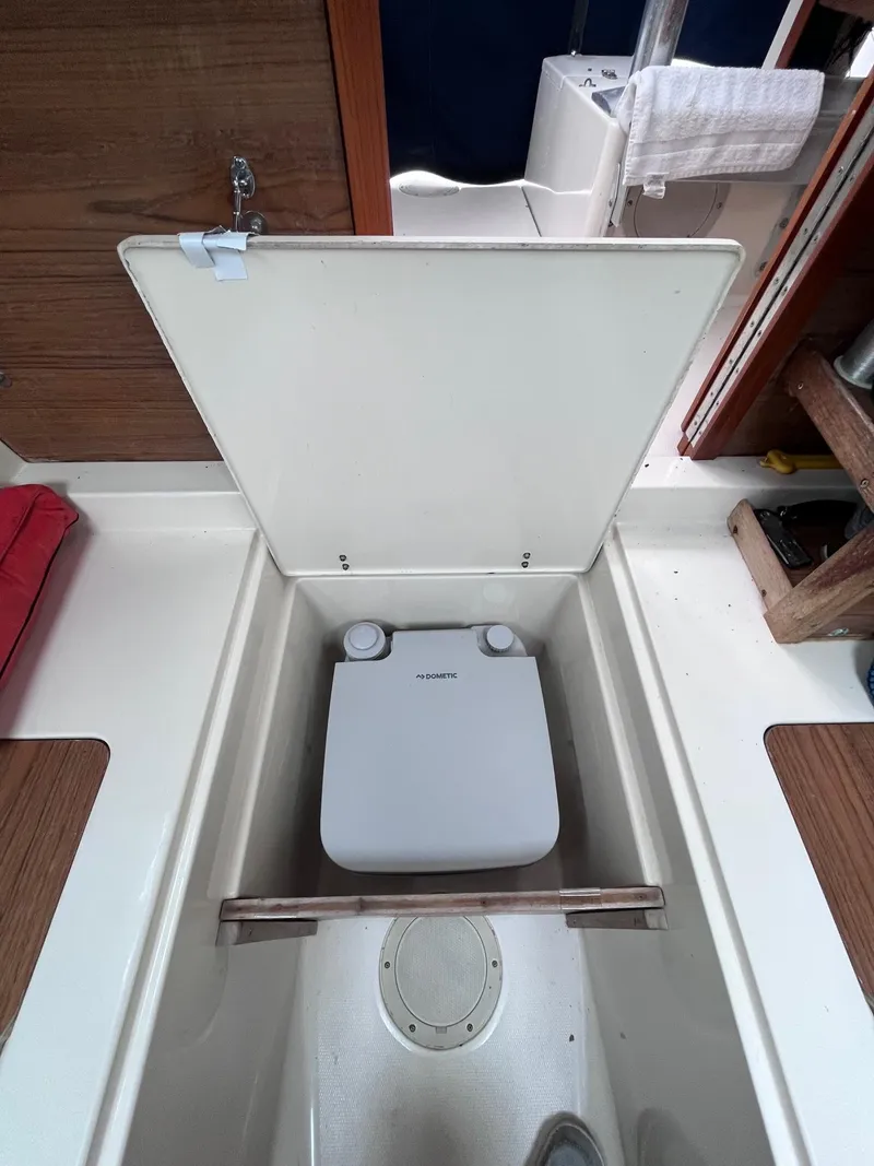 Slide: The Image of 1987 Grady-White 24 Offshore boat interior with built-in portable toilet. - 6