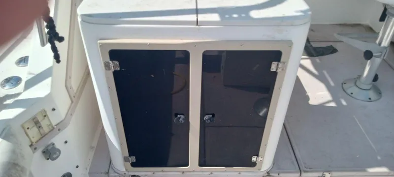 Slide: The Image of 1994 Albemarle 27sf boat storage compartment with black doors. - 10