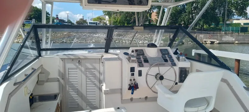 Slide: The Image of 1994 Albemarle 27sf boat cockpit with steering wheel and control panel. - 13