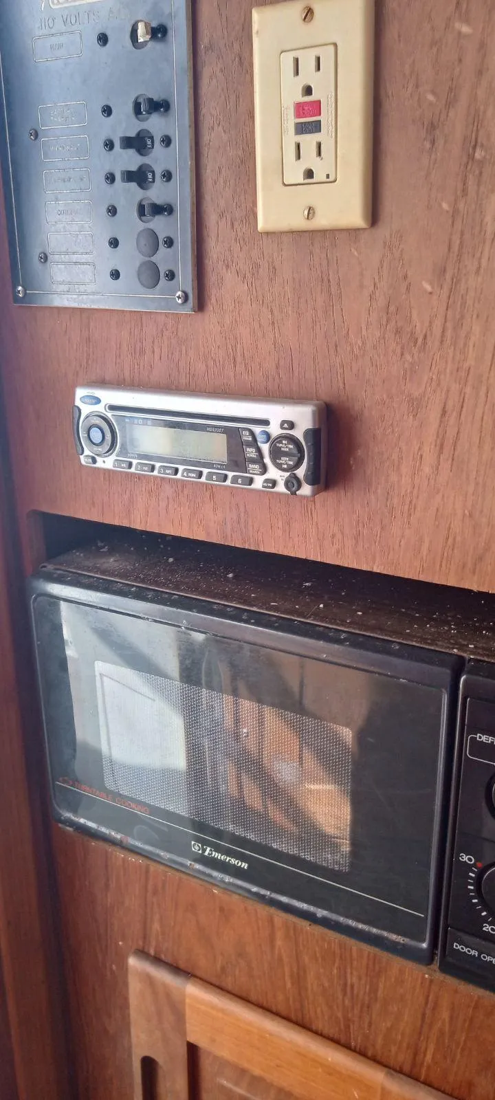 Slide: The Image of Control panel, stereo, and microwave inside a 1994 Albemarle 27sf boat. - 18