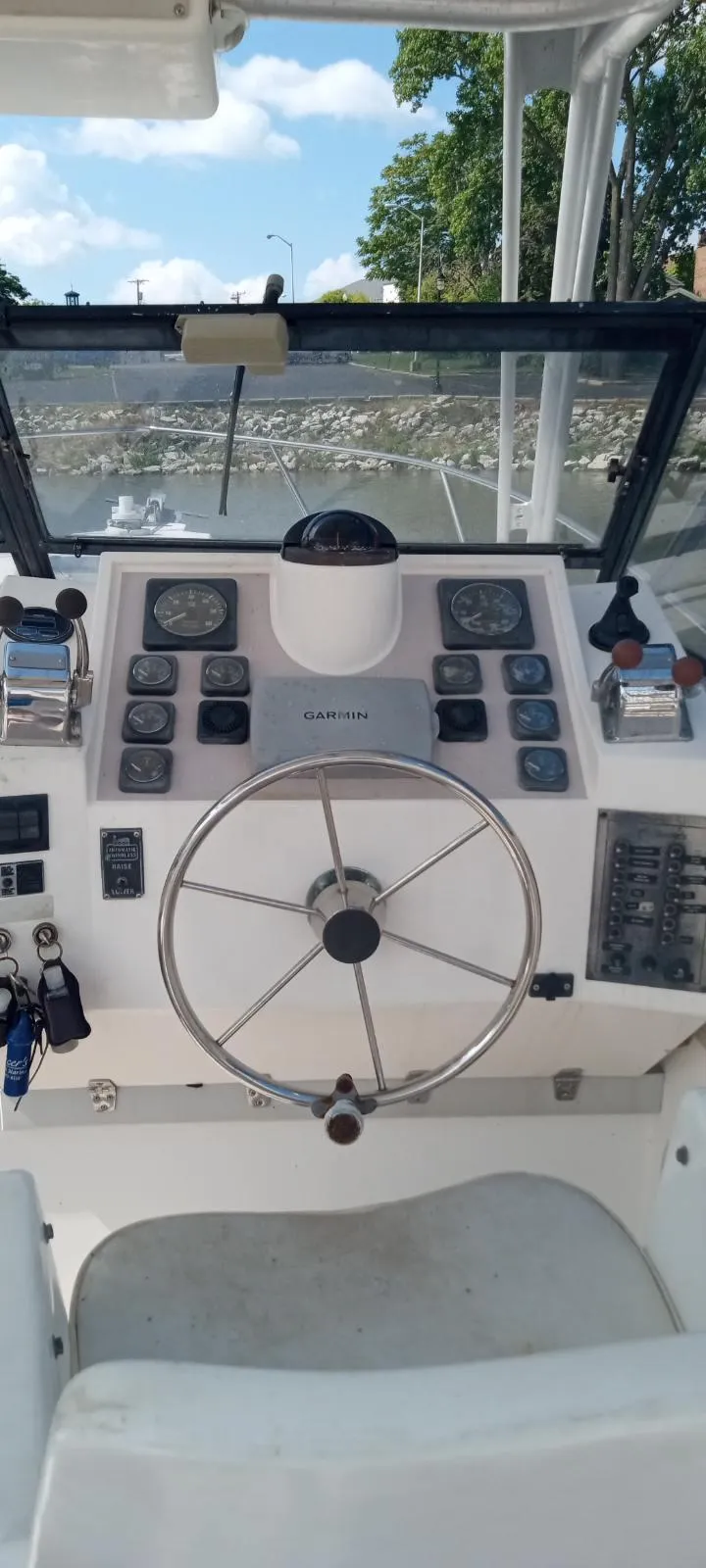 Slide: The Image of 1994 Albemarle 27sf boat dashboard with steering wheel and control panel. - 21
