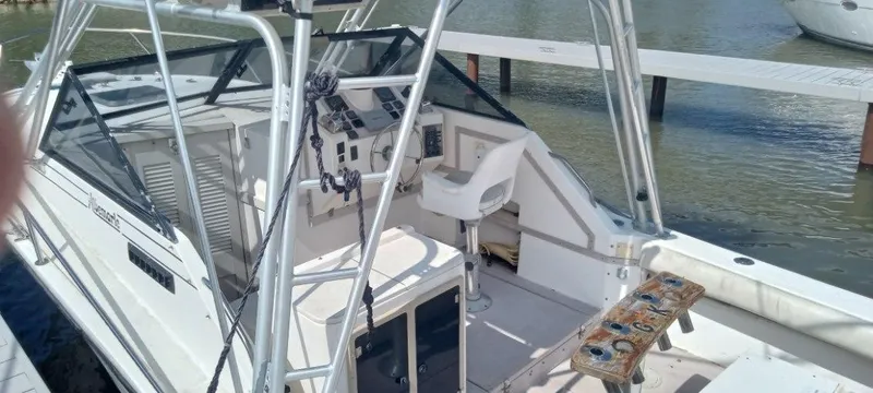 Slide: The Image of 1994 Albemarle 27sf boat interior with helm station and fishing rod holders. - 22