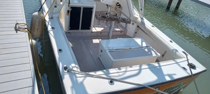 Slide: The Image of 1994 Albemarle 27sf boat docked, rear view showing spacious deck and fishing equipment. - 26