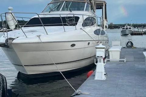 Slide: The Image of 2004 Cruisers Yachts 405 Express Motoryacht docked at marina, front view. - 1